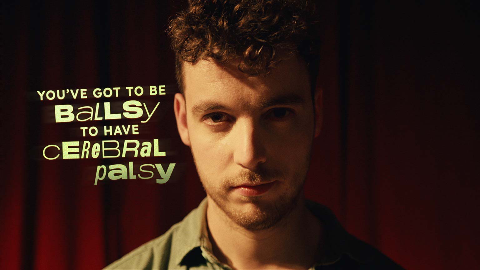 Person in front of a dark red curtain, with the phrase 'You've got to be ballsy to have cerebral palsy' written beside them.